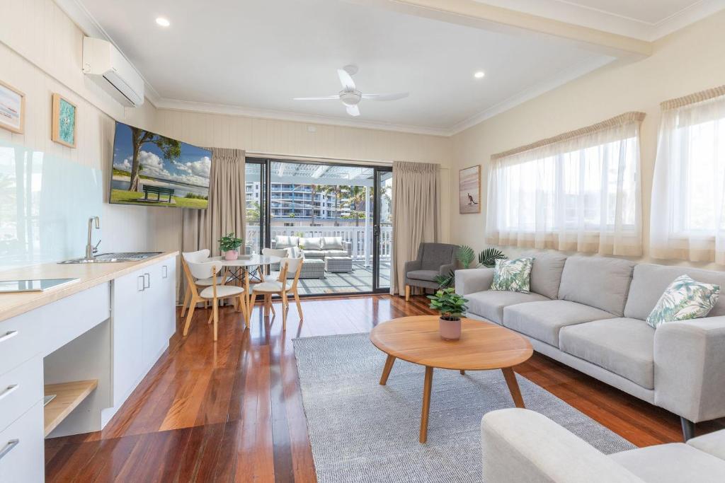 a living room with a couch and a table at Jasmine Apartment in Forster