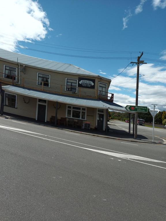 a building on the side of a road with a street sign at Ahaura Hotel in Greymouth