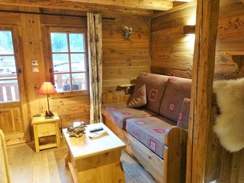 a living room with a couch in a log cabin at Chalet Arêches-Beaufort, 3 pièces, 4 personnes - FR-1-342-220 in Beaufort