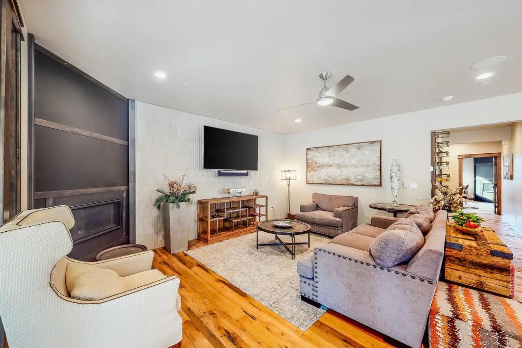 a living room with a couch and a tv at Gondola Vista Luxury Villas by Ski Heavenly & Beaches in South Lake Tahoe