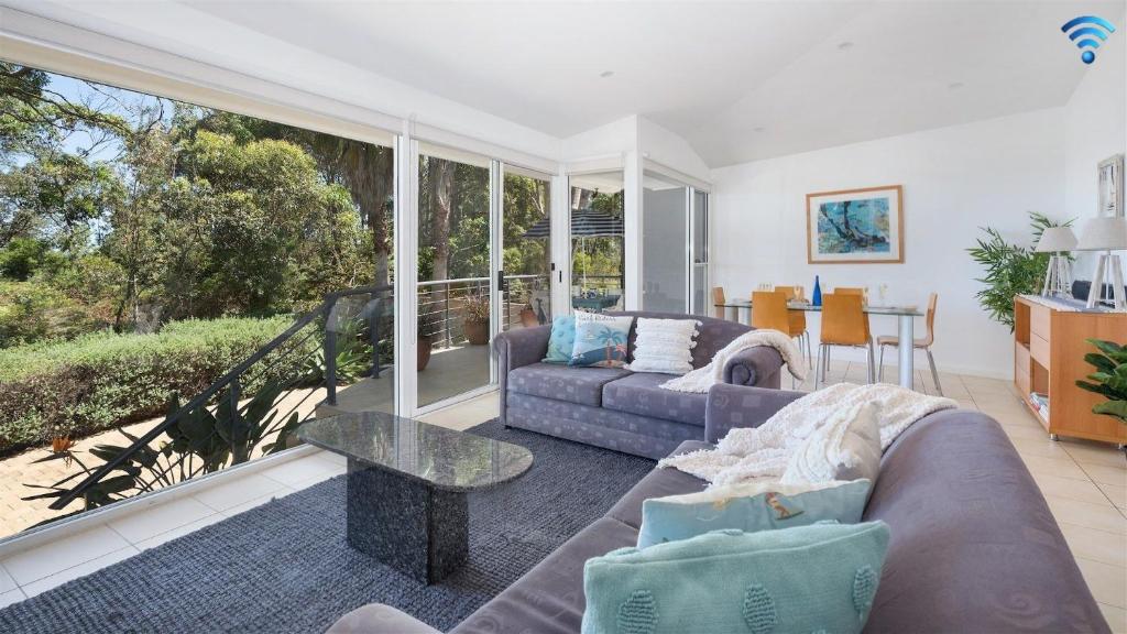 a living room with a couch and a table at Jervis Shores in Callala Bay