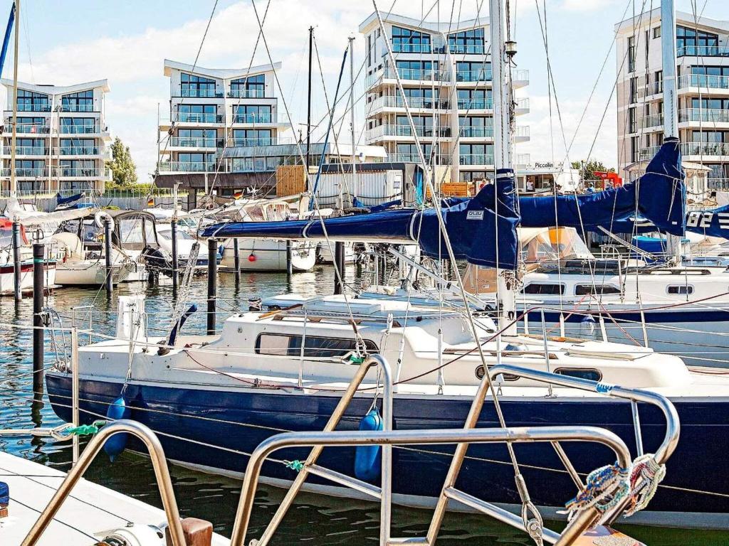 a group of boats docked in a marina with tall buildings at Apartment Wendtorf VII in Wendtorf