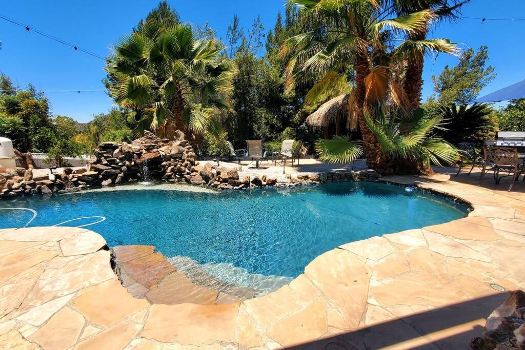 a swimming pool in a backyard with a resort at Special Vacation House/ Pool & Basketball Court in El Cajon