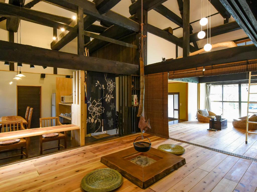 a living room with a table in the middle of a room at さいの郷「椛」 in Kagamino