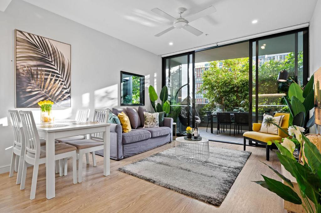 a living room with a couch and a table at Southbank Heart+2 Bed+Balcony+Pool+Gym+Free Wifi in Brisbane