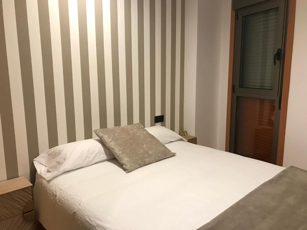 A bed or beds in a room at Apartamento La Buena Vida
