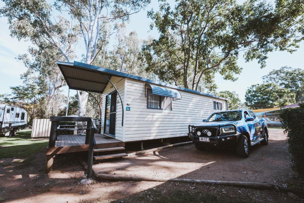 a truck parked in front of a tiny house at BIG4 Breeze Holiday Parks - Cania Gorge in Cania