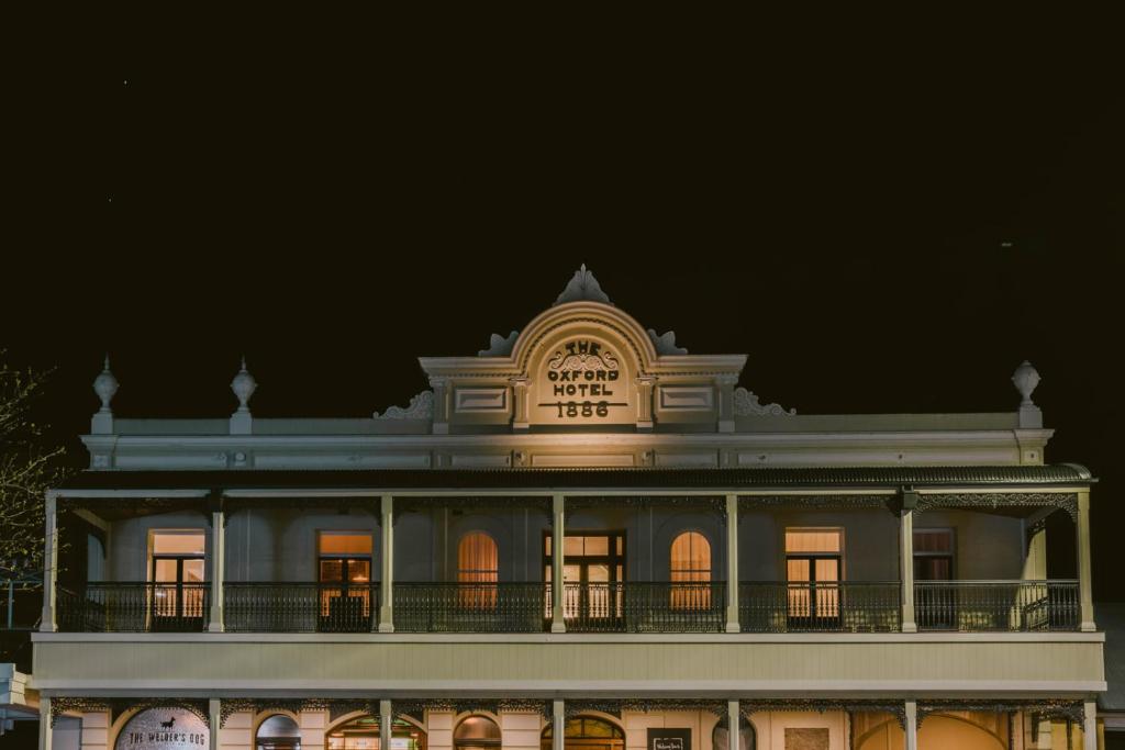 a building with a clock on top of it at night at Oxford on Otho in Inverell