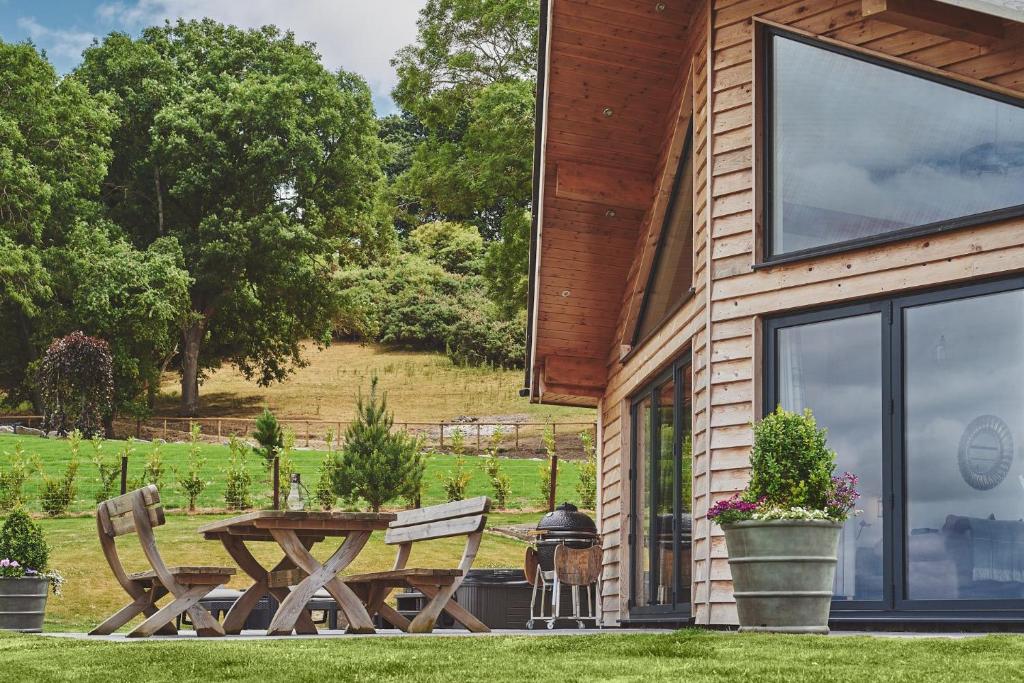 a patio with a table and chairs next to a house at Shepherds Rest in Llandyssil