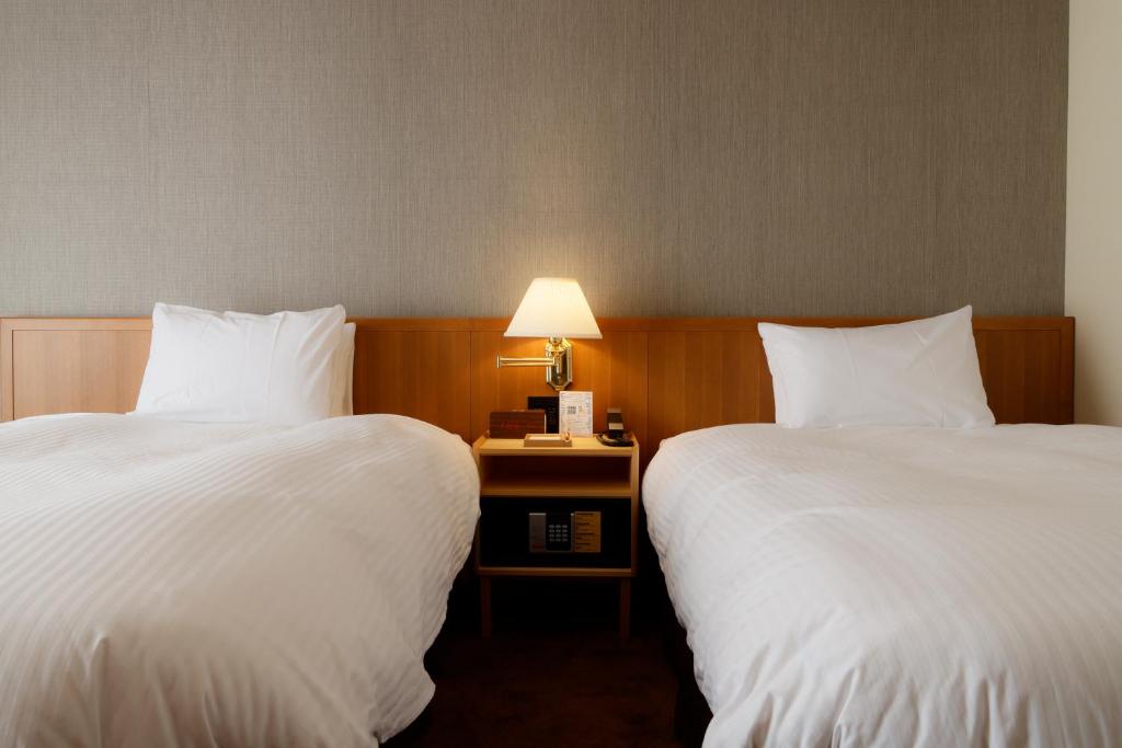 Postel nebo postele na pokoji v ubytování Hotel Nara Sakurai No Sato