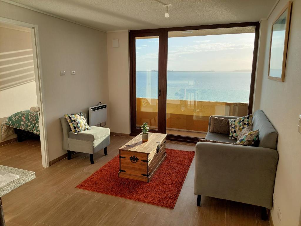 a living room with a view of the ocean at Departamento con preciosa vista al mar y ciudad in Puerto Montt