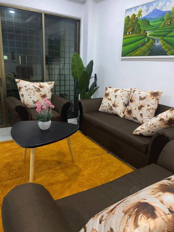 a living room with a couch and a table at Islamic Homestay Promenade Tanjung Lumpur in Kuantan