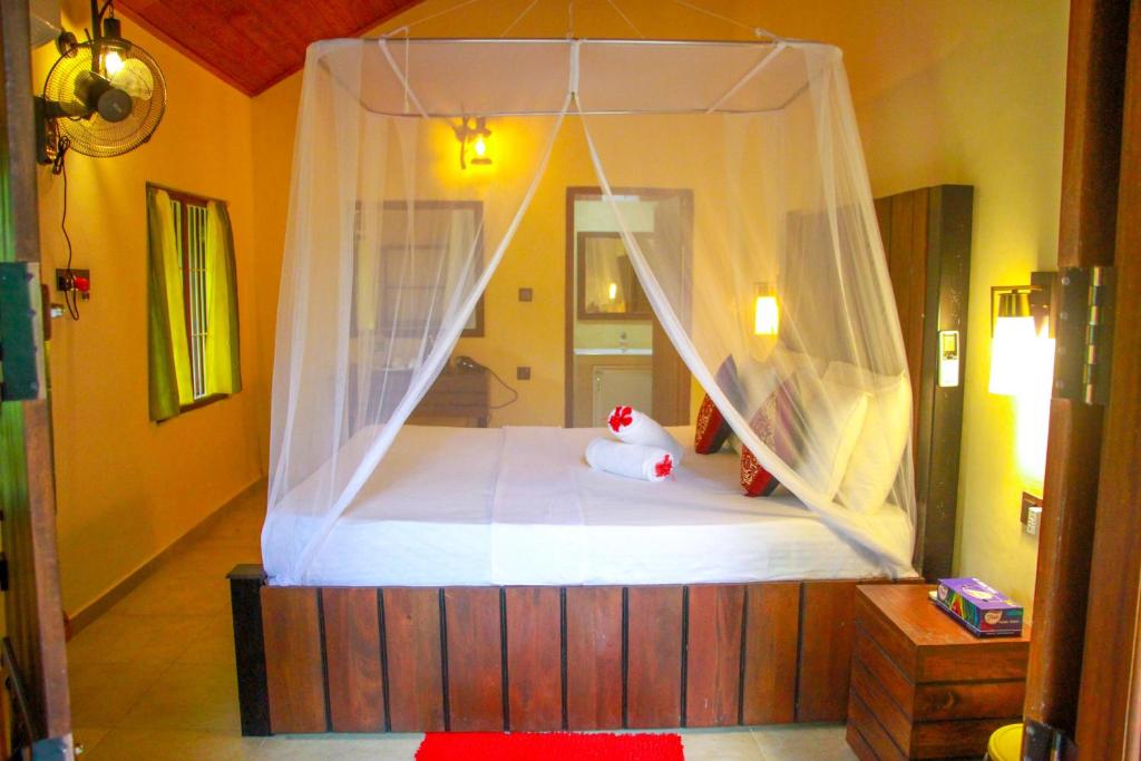 Postel nebo postele na pokoji v ubytování Machcha Lodge Sigiriya
