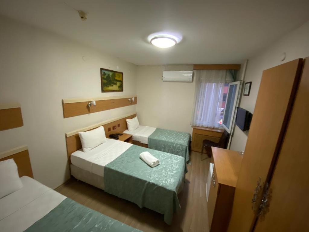 A bed or beds in a room at Hotel Oz Villa
