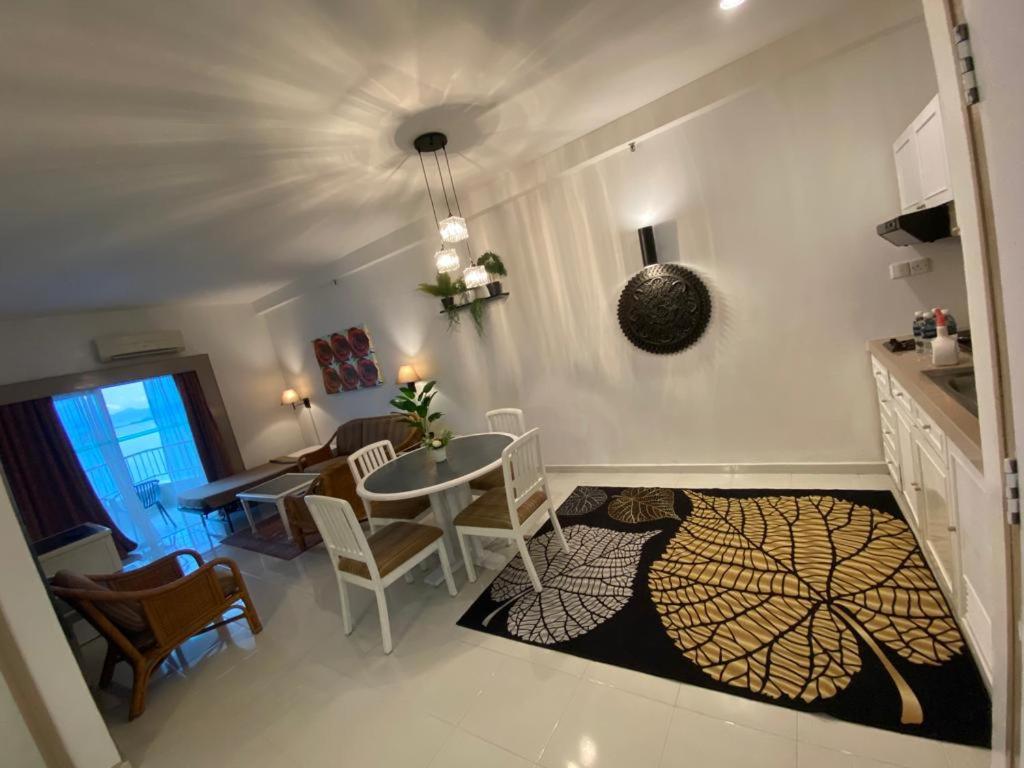 a kitchen and dining room with a table and chairs at Seaview Deluxe@Rainbow Paradise Tg Bungah 4-6pax in Tanjung Bungah