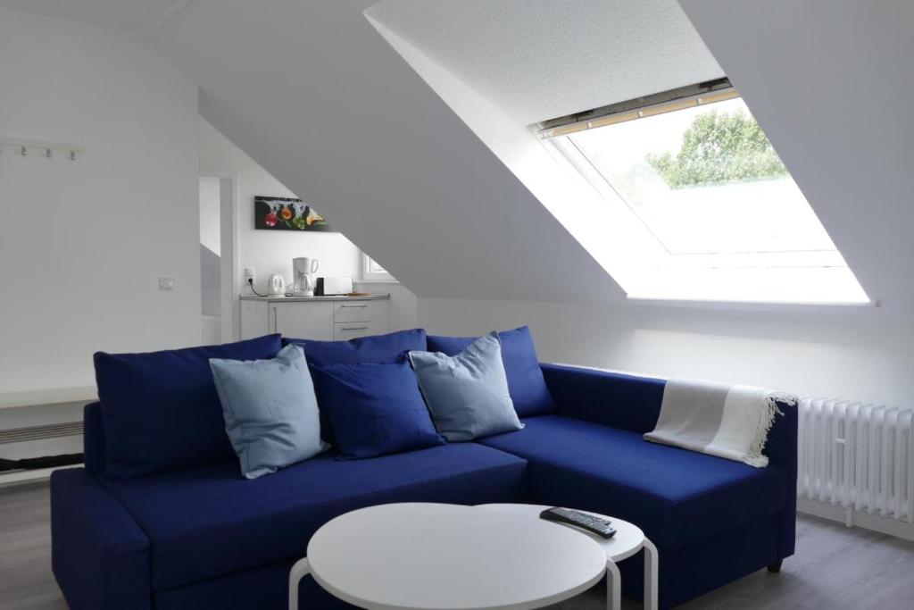 a blue couch in a living room with a window at Baltic Nr. 24 in Scharbeutz