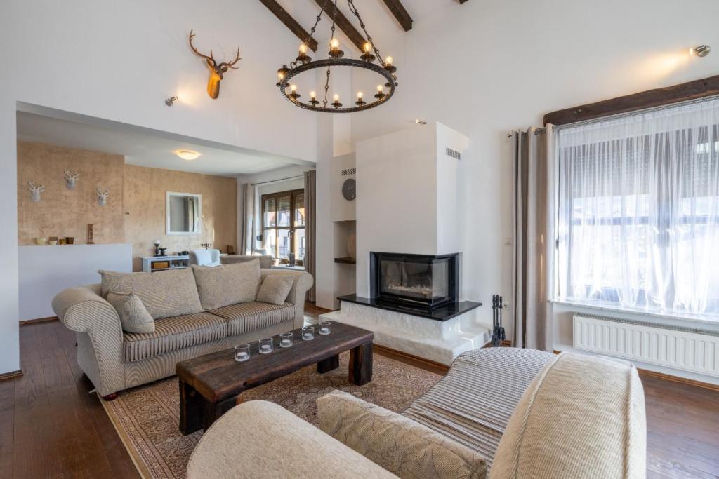 a living room with a couch and a fireplace at Kuca za odmor M11 in Kupres