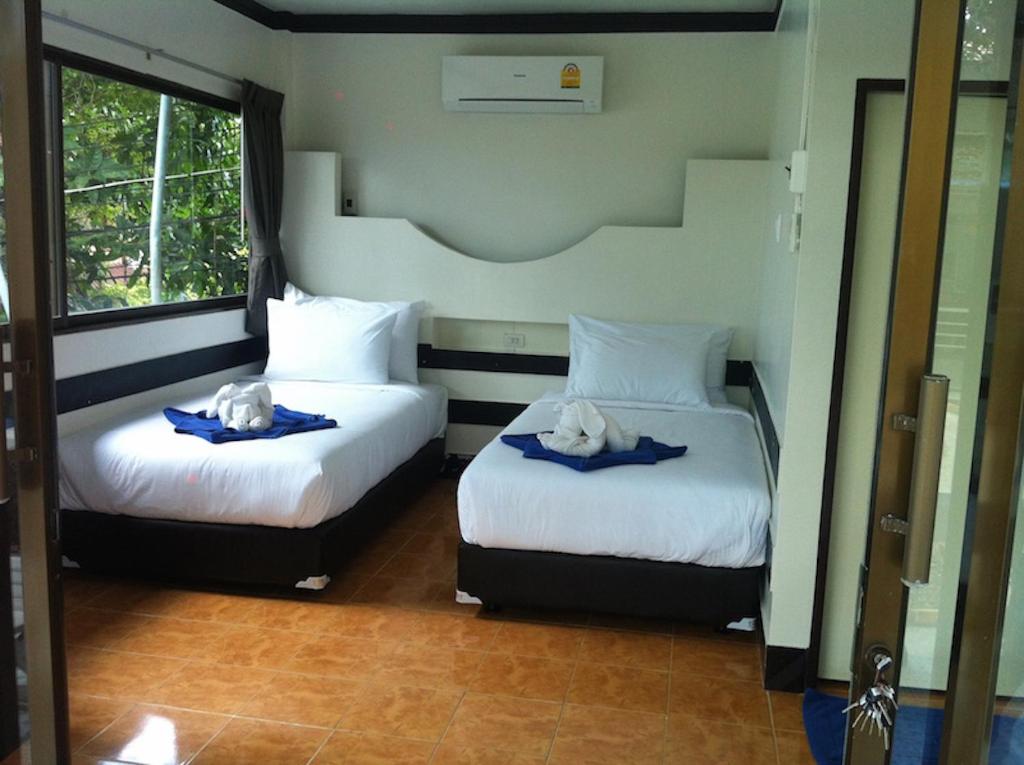 Postel nebo postele na pokoji v ubytování Simple Life Talay & Divers Resort