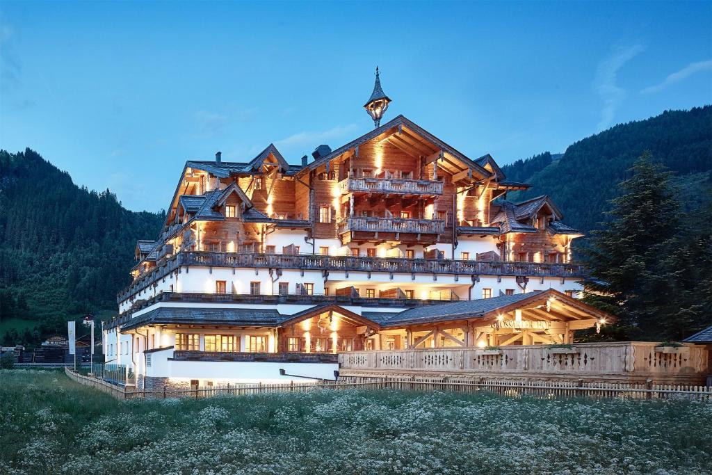 a large wooden house on top of a mountain at Grossarler Hof Superior in Grossarl