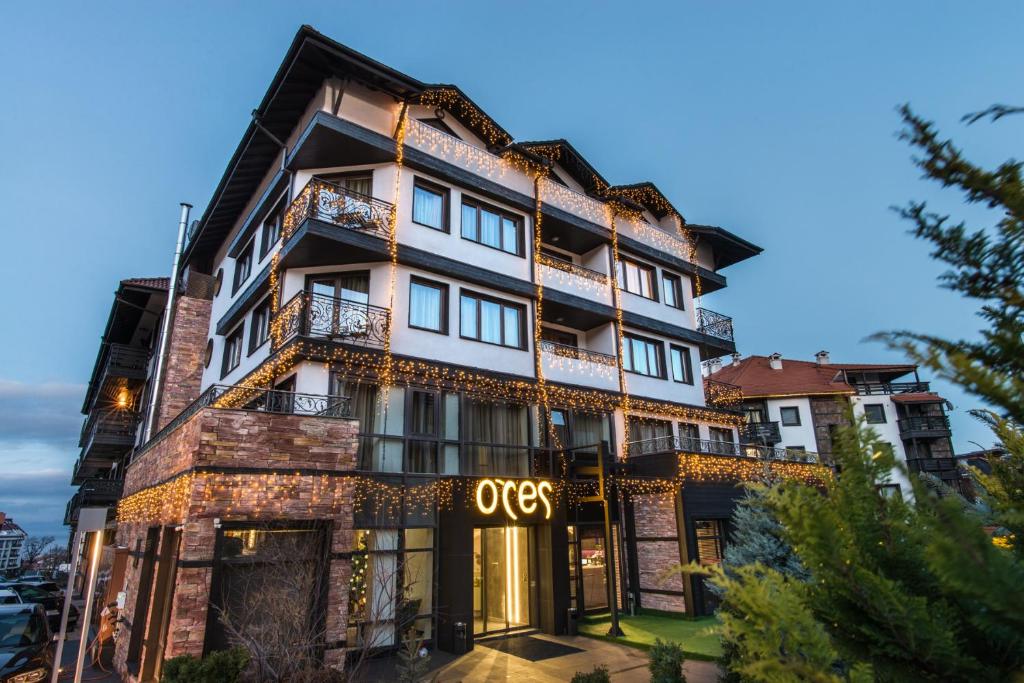 an apartment building with an oss sign on it at Ores Boutique Hotel in Bansko