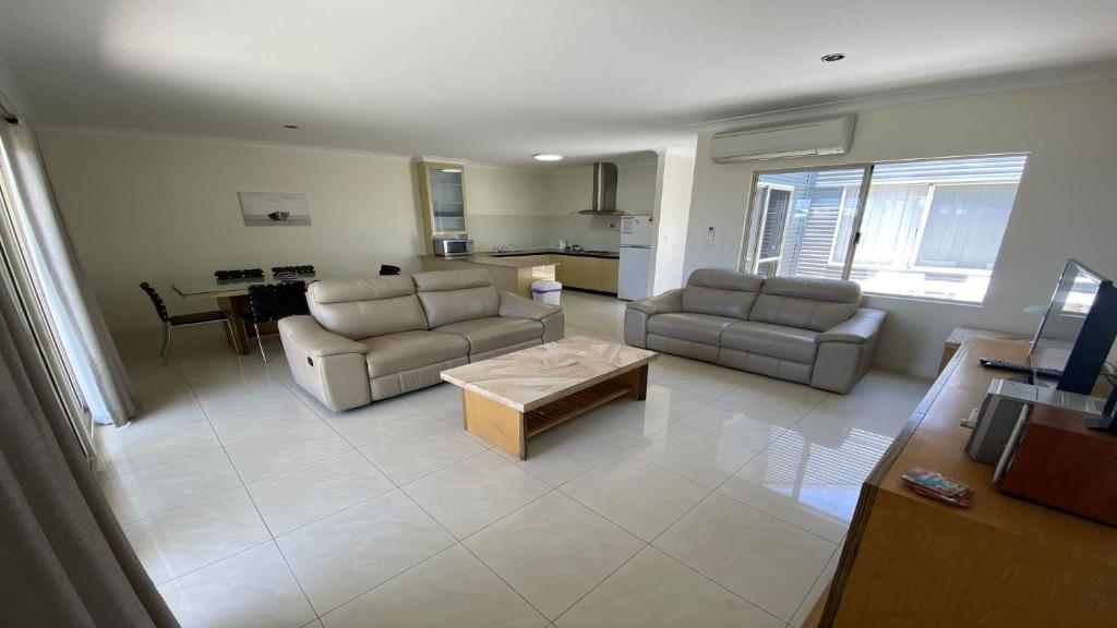 a living room with two couches and a coffee table at Unit 64 Seafront Estate in Jurien Bay