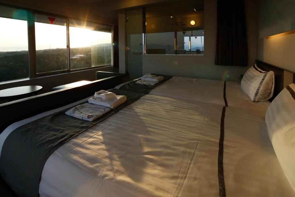 Postel nebo postele na pokoji v ubytování KOKO HOTEL Numazu Inter