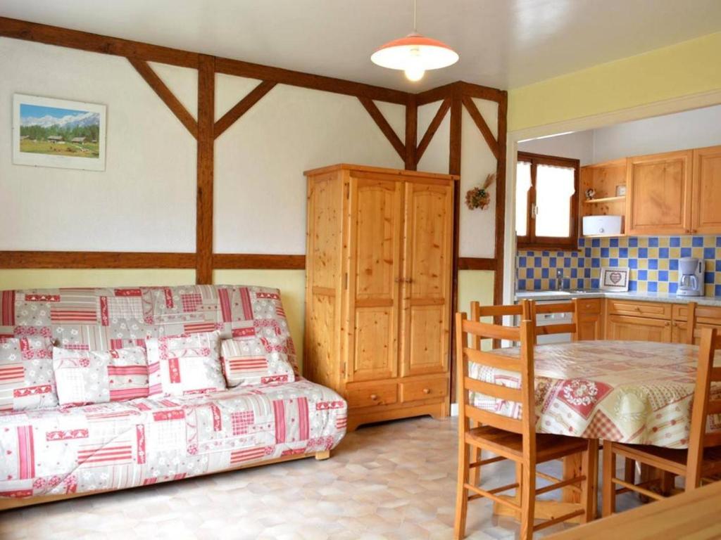 a bedroom with a bed and a table and chairs at Appartement Le Grand-Bornand, 2 pièces, 6 personnes - FR-1-241-106 in Le Grand-Bornand