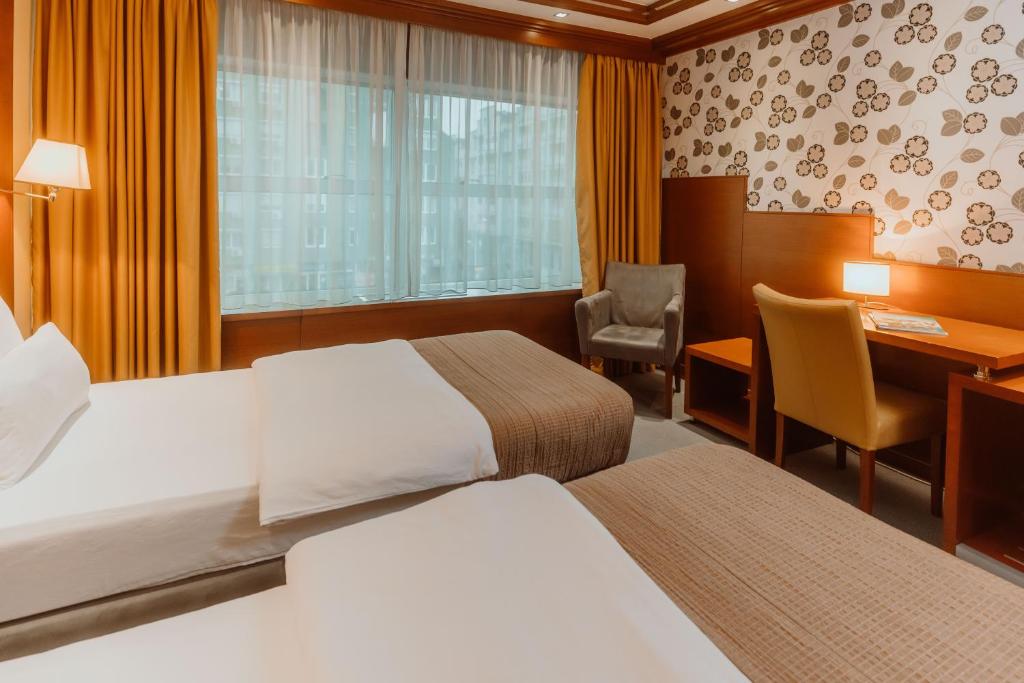 Postel nebo postele na pokoji v ubytování Garni Hotel Aleksandar
