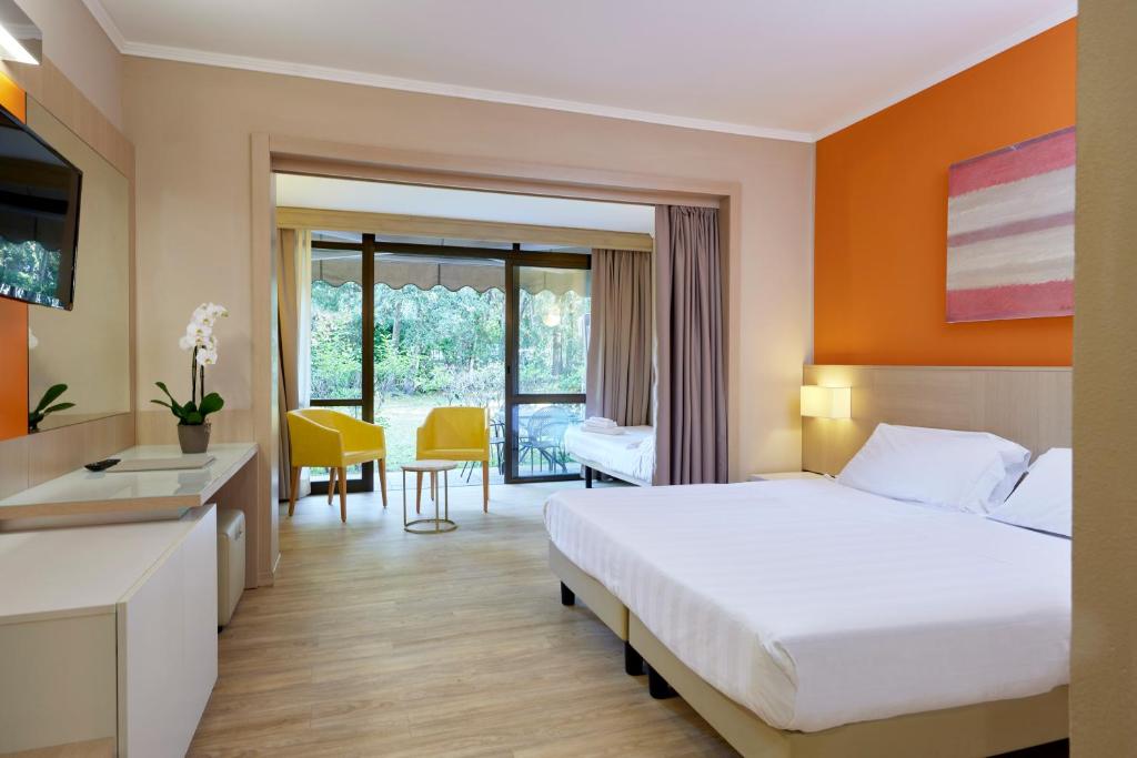 Ein Bett oder Betten in einem Zimmer der Unterkunft Park Hotel I Lecci