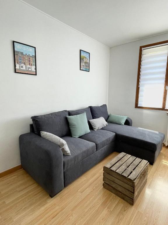 un salon avec un canapé gris et une table dans l'établissement Gounod - maison proche de la mer Le Tréport, au Tréport