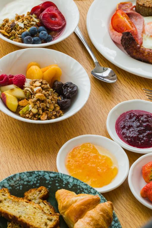 a table with plates of breakfast foods on it at Dunmore House Hotel in Clonakilty