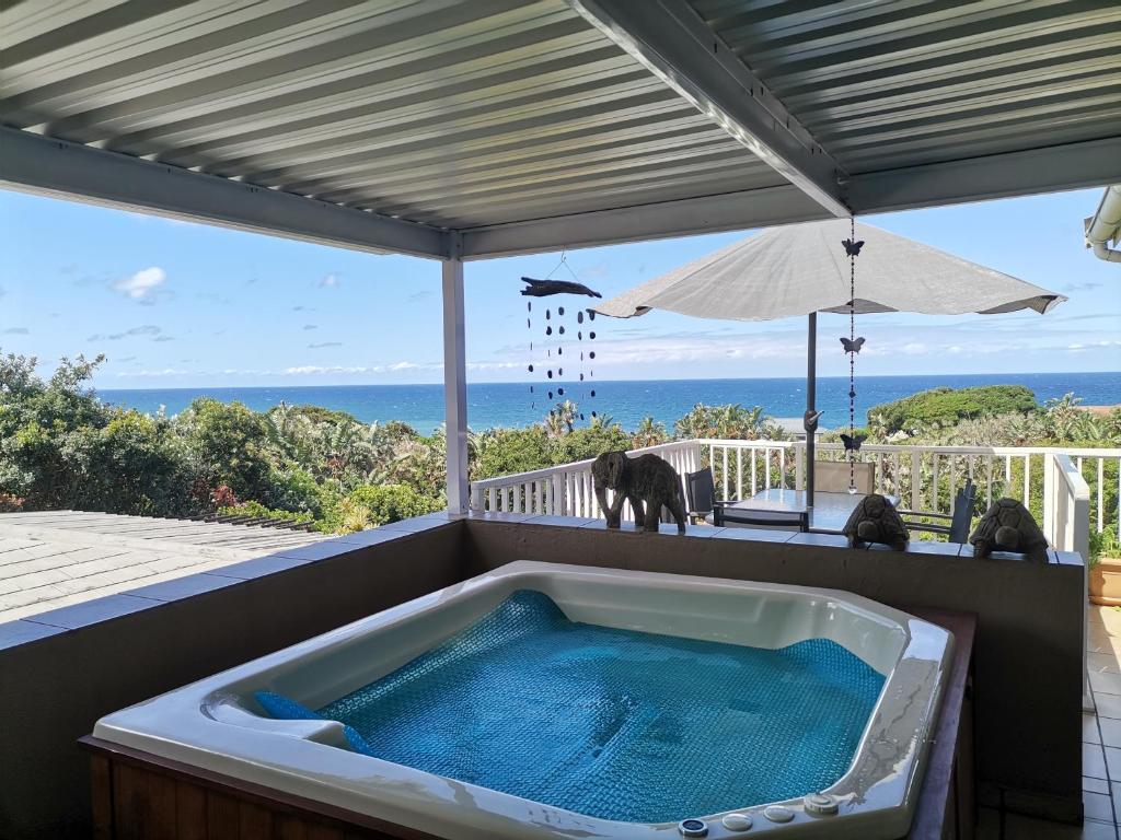 a hot tub on a patio with an elephant in it at Ridgeview Holiday Accommodation in Umzumbe