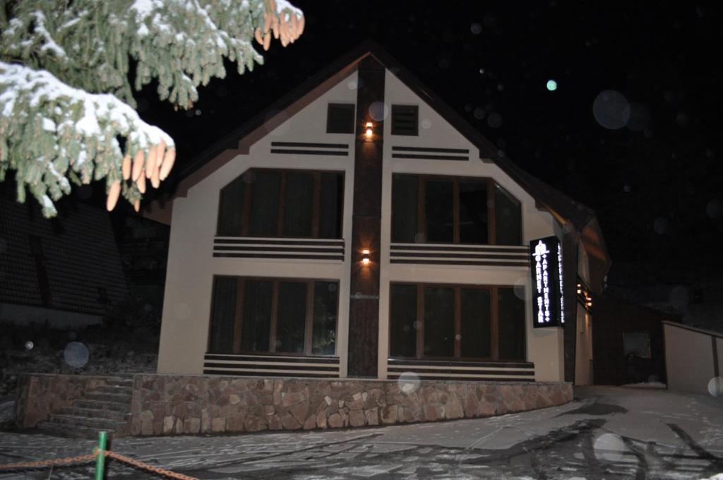 a house is lit up at night at Garnet Star Apartments, Kopaonik, apartman broj 4 in Kopaonik