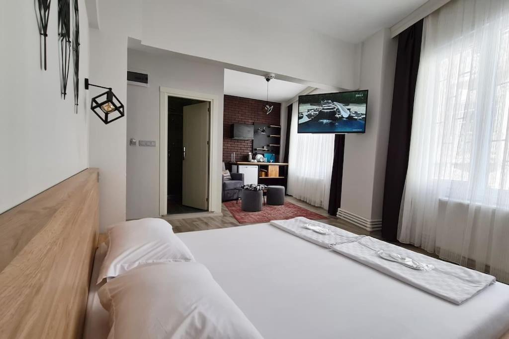 a bedroom with a bed and a flat screen tv at Social House in Istanbul