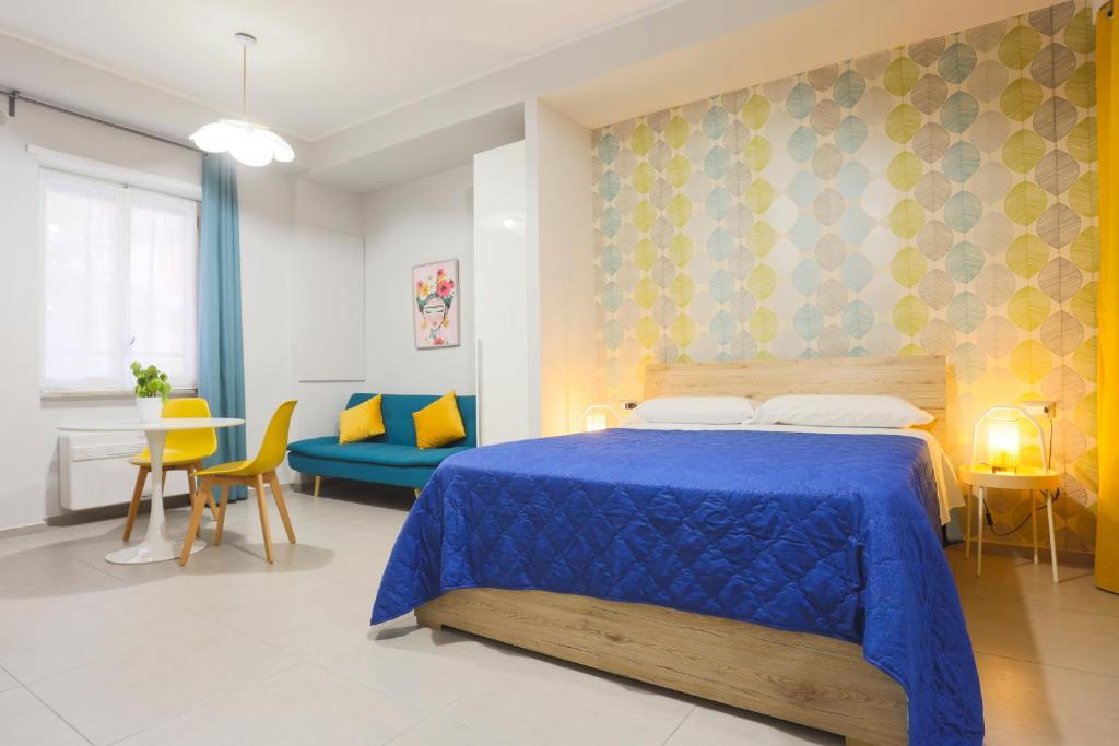 a bedroom with a blue bed and a dining room at Le stanze di Mami in Salerno