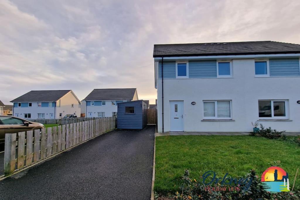 a white house with a fence and a yard at 18 Gold Drive, Kirkwall, Orkney - OR00185F in Orkney