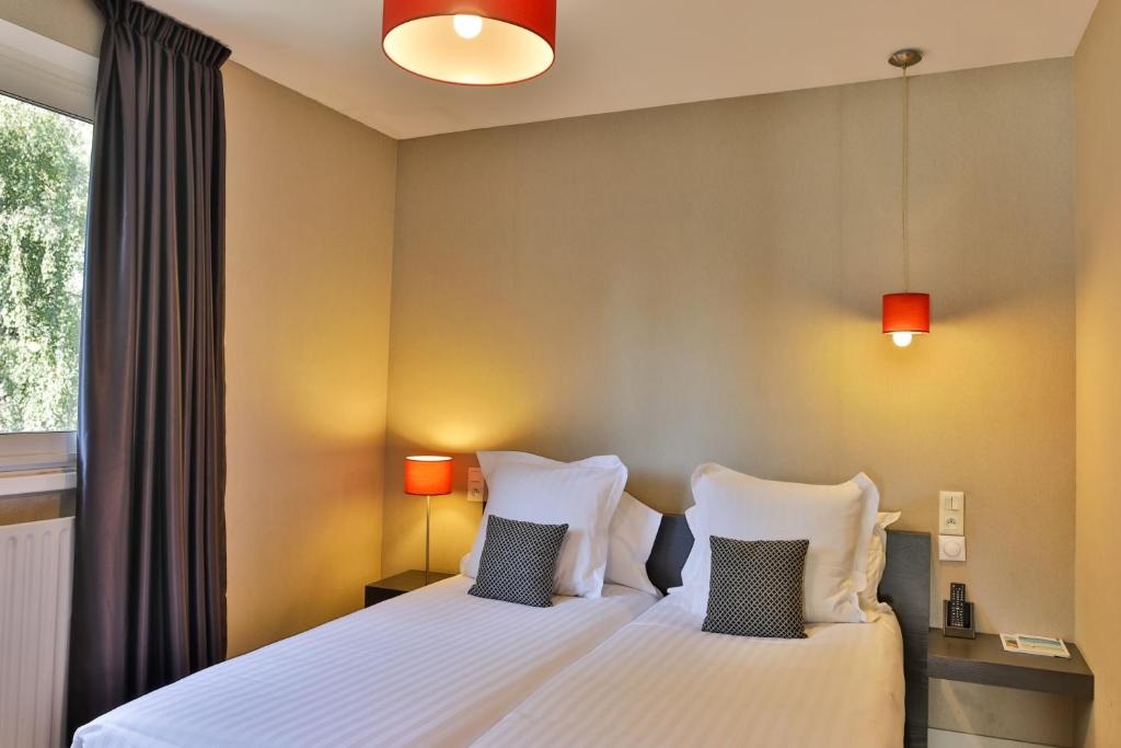 Postel nebo postele na pokoji v ubytování Le Galet Hotel & Spa
