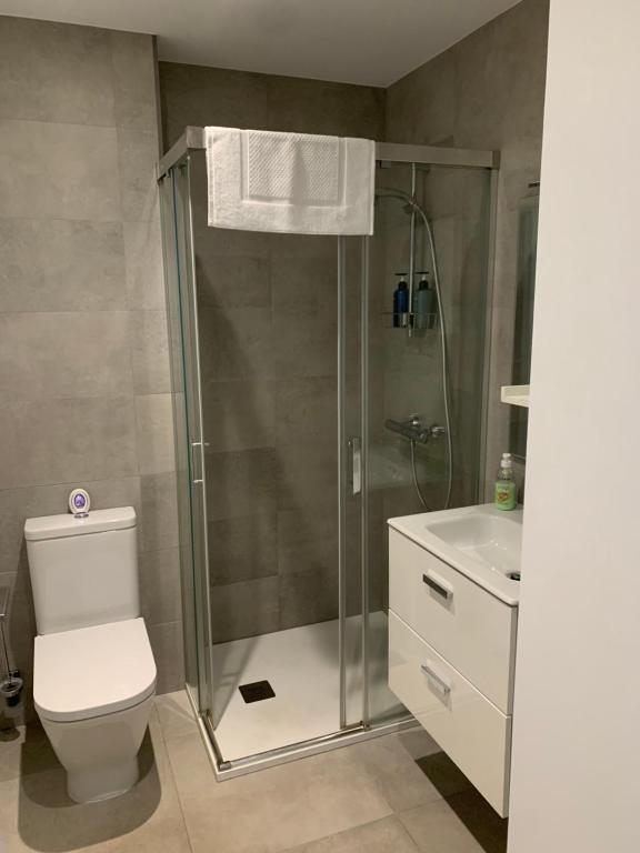 a bathroom with a shower and a toilet and a sink at CP High floor luxury studio in Gibraltar