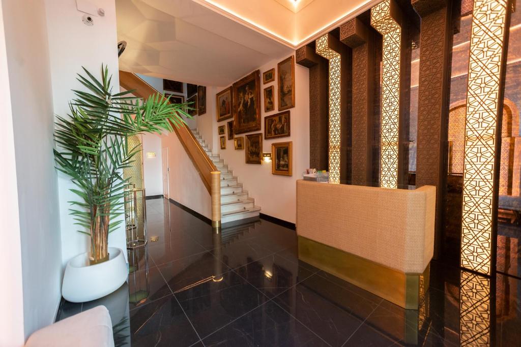 a hallway with a staircase and a potted plant at Hotel Casa Palacio la Sal in Córdoba