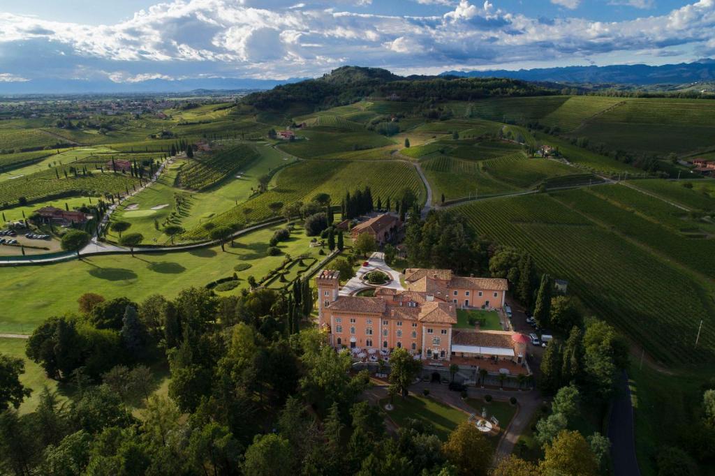 an aerial view of a mansion in a green field at Castello Di Spessa - Residenze d'epoca in Capriva del Friuli