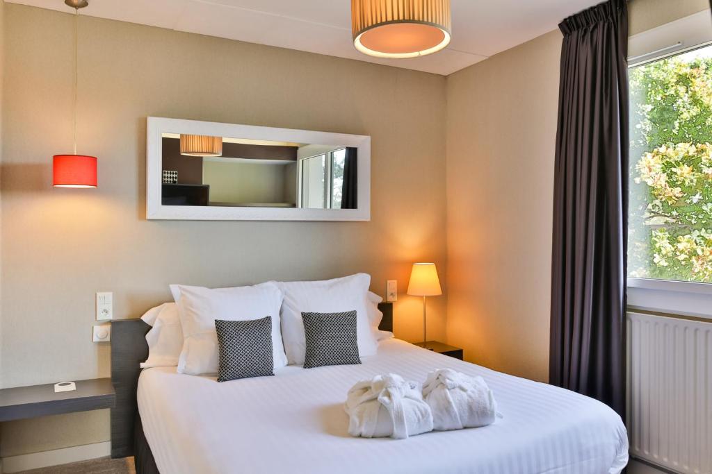 Postel nebo postele na pokoji v ubytování Le Galet Hotel & Spa
