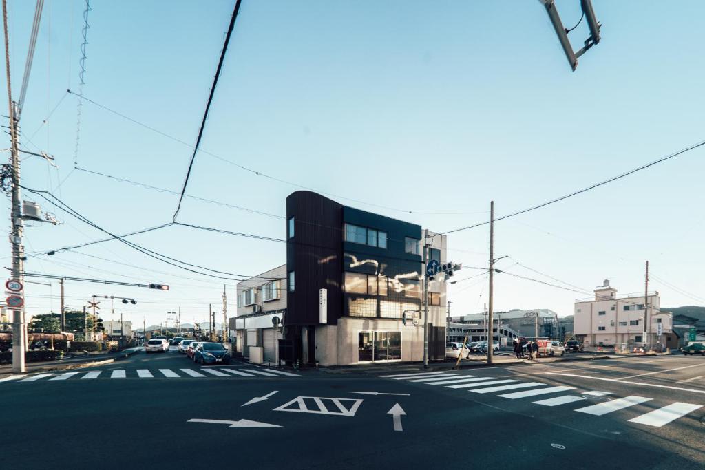 an intersection with a building on a city street at SLEEEP JP Fujinomiya in Fujinomiya