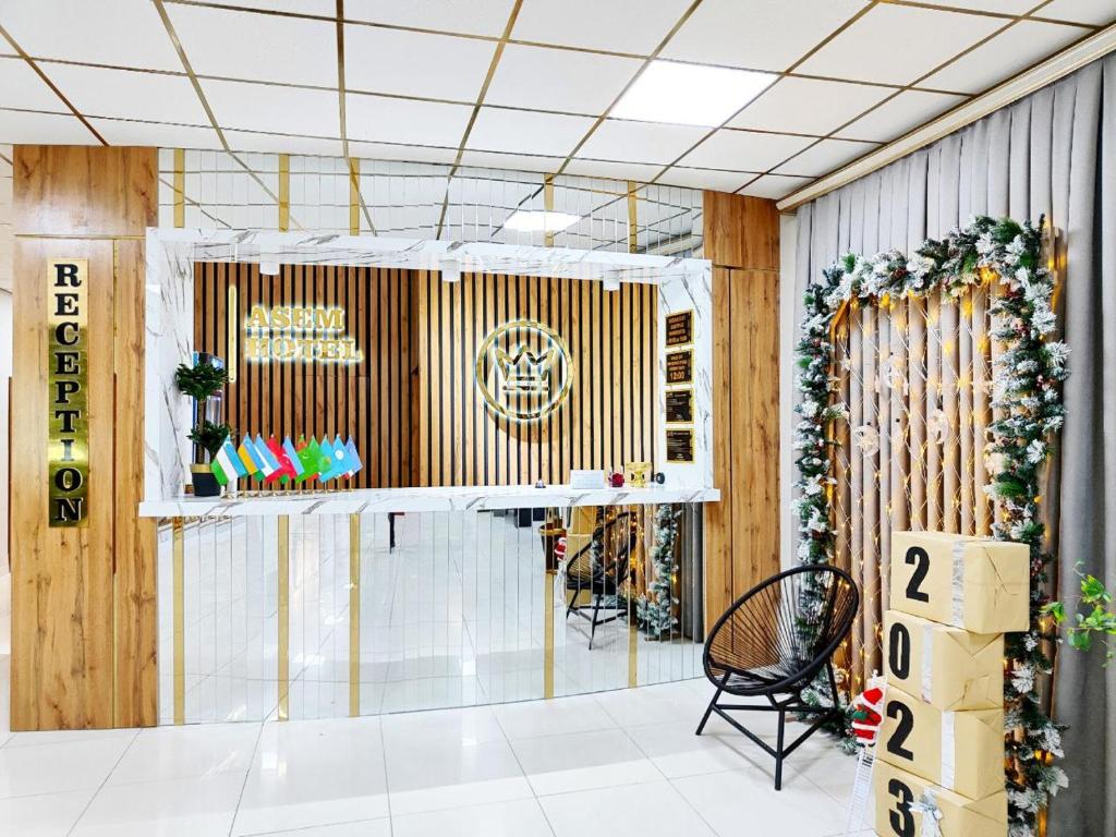 a lobby with wooden walls and a table and chairs at Asem Hotel in Nukus