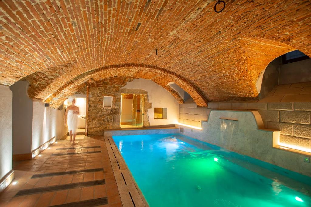 a pool in a building with a brick ceiling at Casual Rinascimento Firenze in Florence