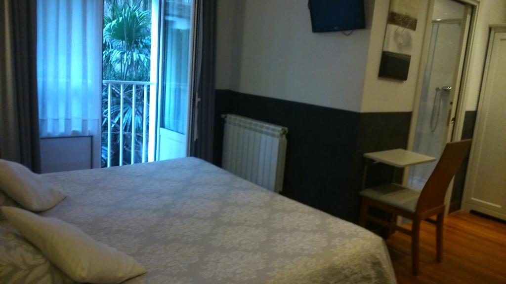 Posteľ alebo postele v izbe v ubytovaní Hostal San Sebastian Centro