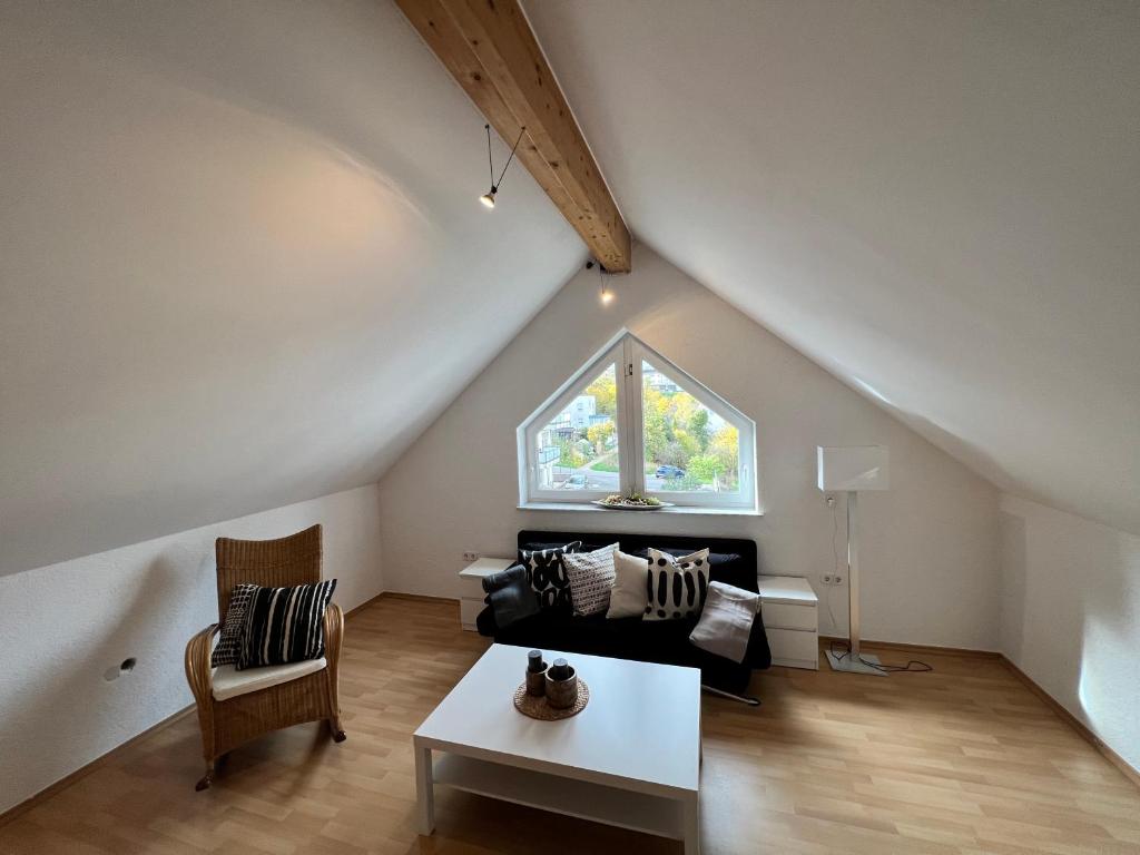 a living room with a couch and a window at Gerolstein, Urlaub in der Eifel 2 - Ferienwohnung in Gerolstein