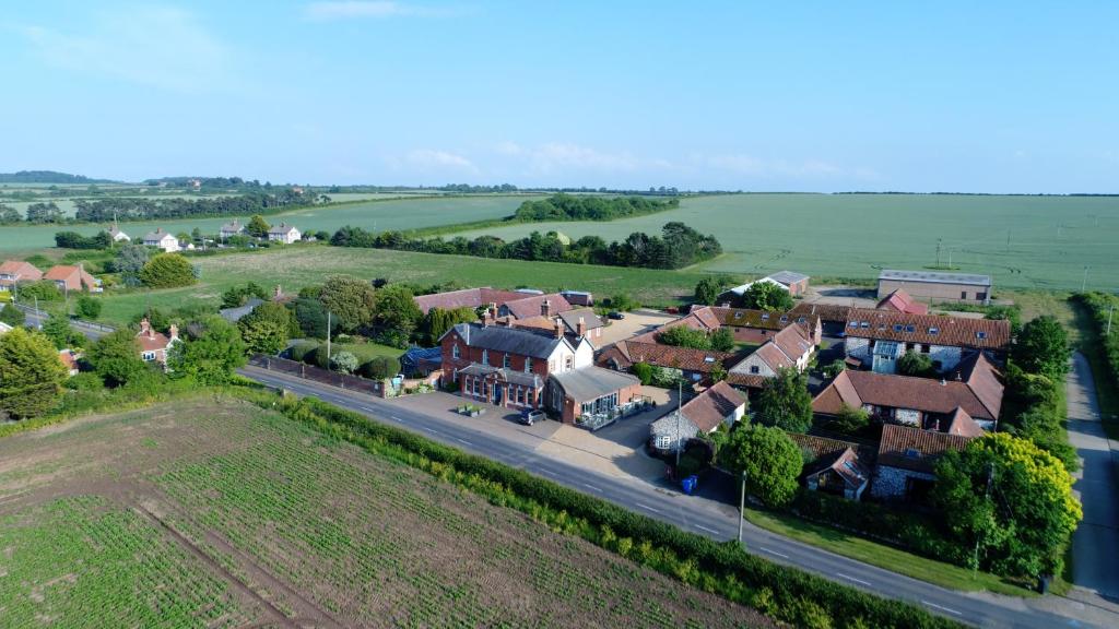 an aerial view of a small village with houses at Titchwell Manor Hotel in Titchwell