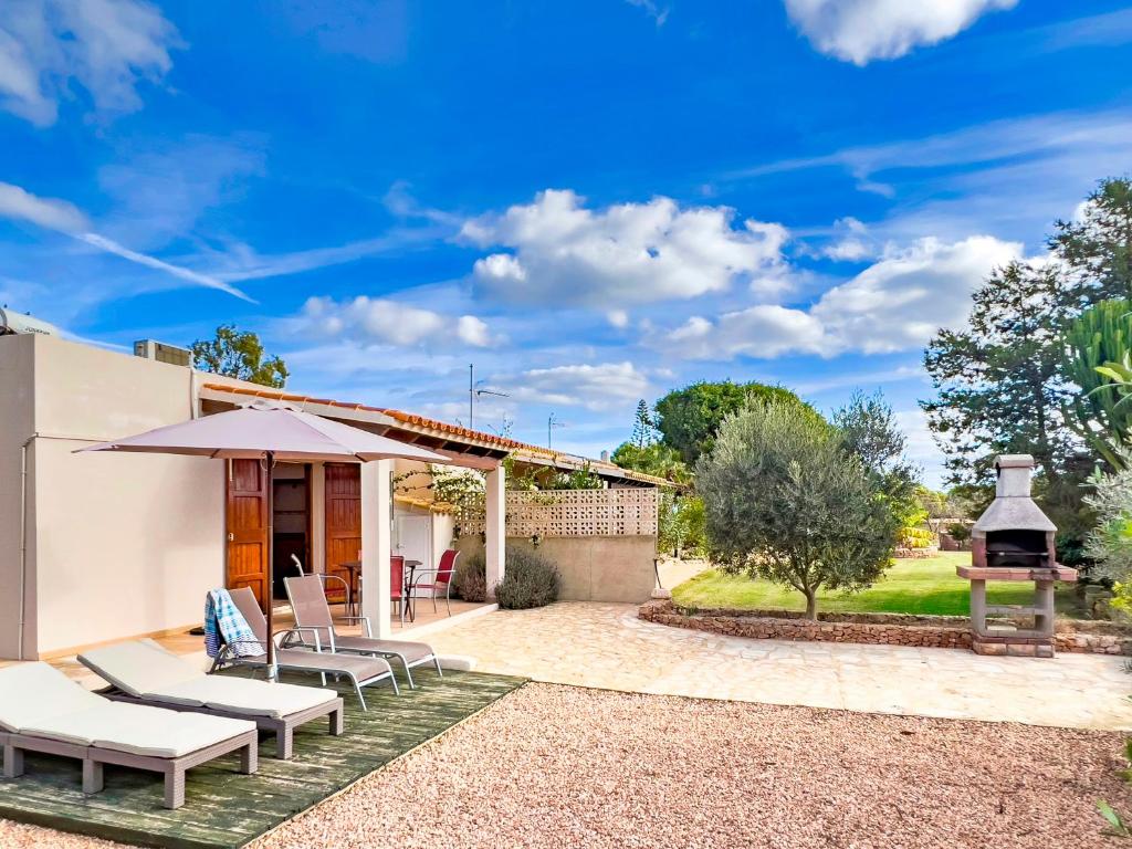 a house with a patio and a fireplace at Can Pep Yern 2 in Playa Migjorn