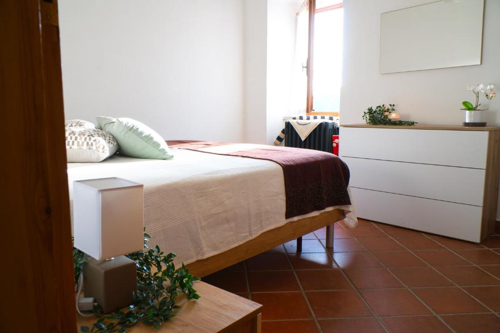 a bedroom with a bed and a dresser at Un Passo dal Cielo...Apartment in San Potito