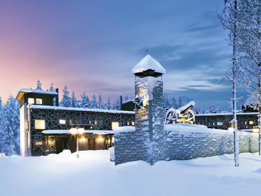 a resort in the snow with a building at Vuokatin Aateli Castle in Vuokatti